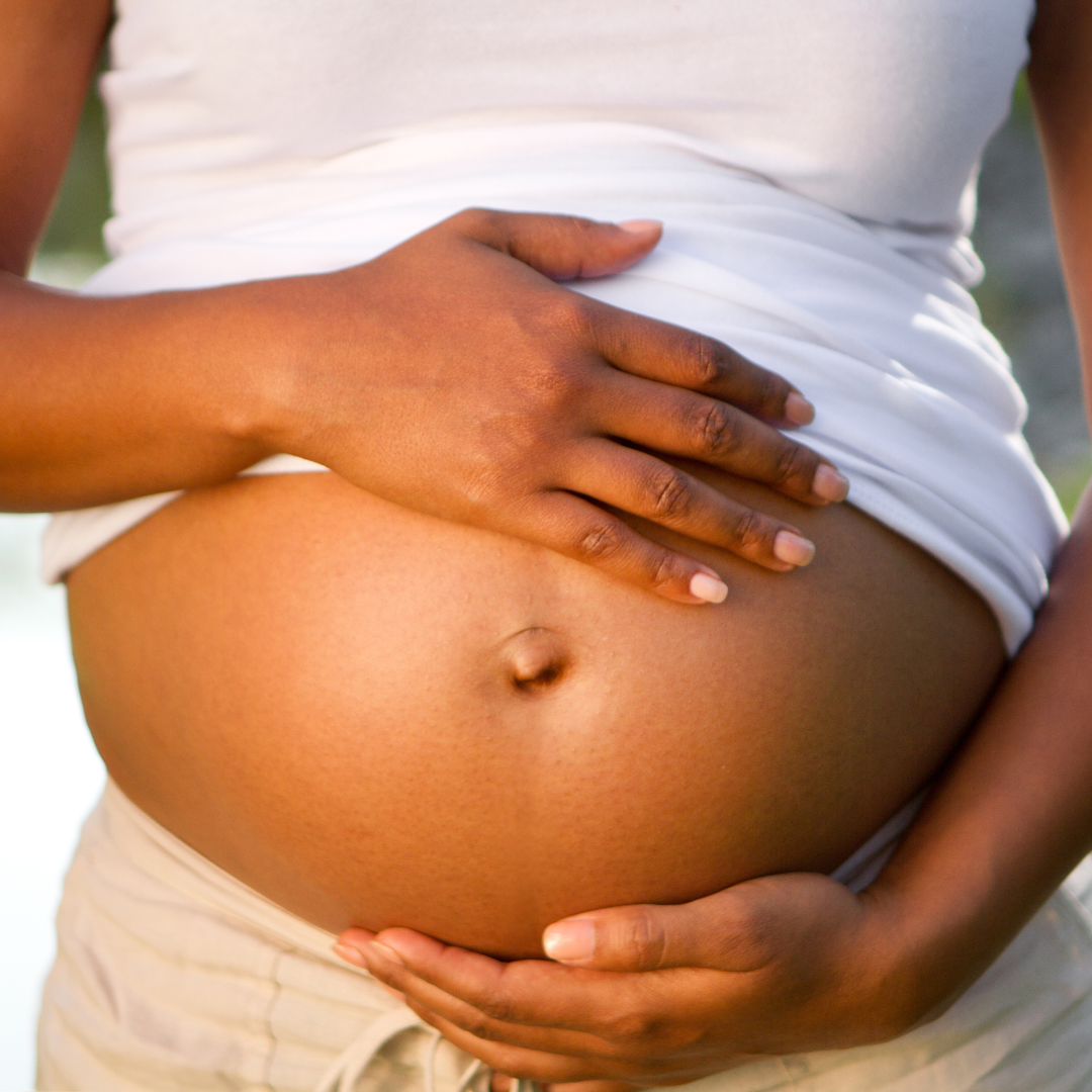 Sleeping pregnant woman is resting on the yellow chair Stock