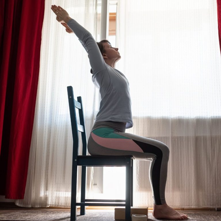 alt="woman doing prenatal yoga in chair"