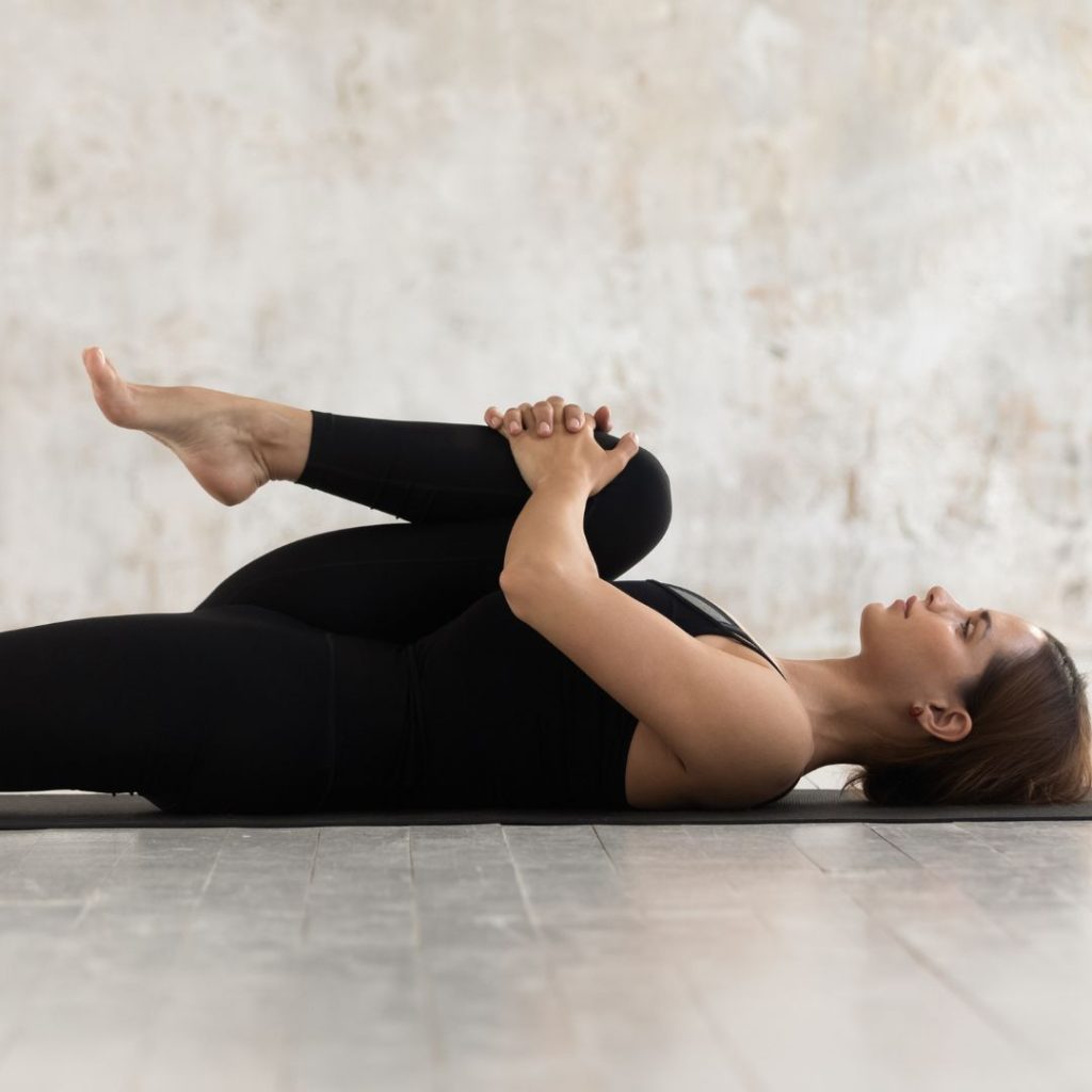 alt="woman doing prenatal yoga psoas release"