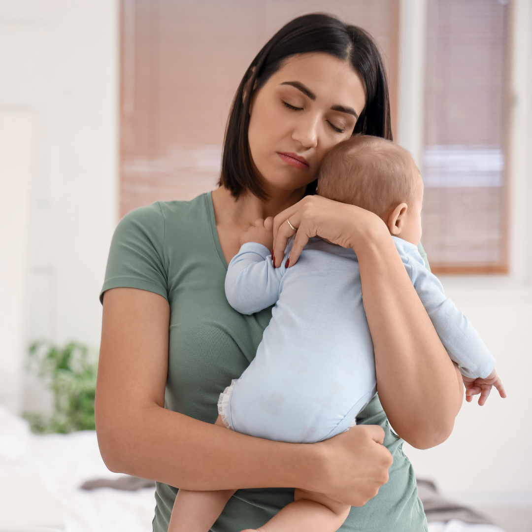 alt=" woman holding baby with perinatal mood and anxiety disorder"